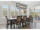 Bright dining room featuring wood floors, modern light fixture, and sliding glass door access to outdoor space at 547 Scrubjay Cir, Castle Rock, CO 80104