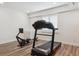 A well-lit exercise room area with hardwood floors, recessed lighting, and fitness equipment at 547 Scrubjay Cir, Castle Rock, CO 80104