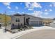 Charming home with well-manicured front yard, a three-car garage, and beautiful stone accents at 547 Scrubjay Cir, Castle Rock, CO 80104