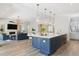 Bright and airy kitchen with an island, stainless steel appliances, and adjacent living room at 547 Scrubjay Cir, Castle Rock, CO 80104