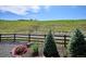 Well-manicured landscaping with flower beds and a rustic wooden fence showcasing peaceful surroundings at 547 Scrubjay Cir, Castle Rock, CO 80104