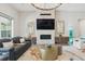 Elegant living room with a fireplace, stylish furniture, and ample natural light at 547 Scrubjay Cir, Castle Rock, CO 80104