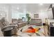 A spacious living room area with hardwood floors, recessed lighting, and comfortable seating at 547 Scrubjay Cir, Castle Rock, CO 80104