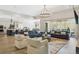 Open concept living room features a spacious layout, recessed lighting, and access to outdoor patio at 547 Scrubjay Cir, Castle Rock, CO 80104