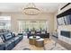 Comfortable living room with fireplace, flat-screen TV, modern lighting, and sliding doors to the yard at 547 Scrubjay Cir, Castle Rock, CO 80104