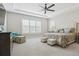 Spacious main bedroom featuring a tray ceiling, shuttered windows, and patterned accent chair at 547 Scrubjay Cir, Castle Rock, CO 80104
