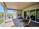 Spacious patio featuring patterned pavers, ample seating, and a picturesque view of rolling hills at 547 Scrubjay Cir, Castle Rock, CO 80104
