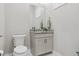 Powder room featuring a granite countertop vanity with sink, framed mirror, and toilet at 547 Scrubjay Cir, Castle Rock, CO 80104