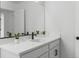 Modern bathroom vanity with white cabinets and quartz countertop at 6350 Stable View St, Castle Pines, CO 80108