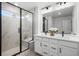 Elegant bathroom with double vanity and a large shower at 6350 Stable View St, Castle Pines, CO 80108