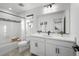 Clean bathroom with white cabinets, quartz countertop, and a bathtub at 6350 Stable View St, Castle Pines, CO 80108