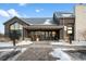 Community center entrance with covered walkway and seating area in winter at 6350 Stable View St, Castle Pines, CO 80108