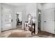 Bright and airy entryway with wood console table, mirror, and view to the living room at 6350 Stable View St, Castle Pines, CO 80108