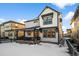 Two-story house with a front porch and fenced backyard in winter setting at 6350 Stable View St, Castle Pines, CO 80108