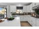 Modern kitchen with white cabinets, herringbone backsplash and island at 6350 Stable View St, Castle Pines, CO 80108