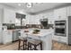 Modern kitchen with white cabinets, herringbone backsplash, and large island at 6350 Stable View St, Castle Pines, CO 80108