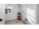 Laundry room with tile floor, shelving and window at 6350 Stable View St, Castle Pines, CO 80108