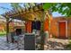 Comfortable backyard patio with a pergola, seating, a grill, privacy curtains, and stone pavers at 1160 York St, Denver, CO 80206
