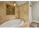 Luxurious soaking tub featuring decorative tile surround and decorative tile inset at 1160 York St, Denver, CO 80206
