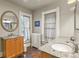 Bathroom featuring a granite countertop, wood cabinets, and decorative mirror and trim at 1160 York St, Denver, CO 80206