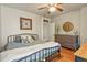 Bedroom with hardwood floors, butterfly-themed decor, and dresser at 1160 York St, Denver, CO 80206