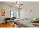 Cozy bedroom featuring hardwood floors, ceiling fan, and desk and chair at 1160 York St, Denver, CO 80206