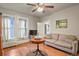 Comfortable bedroom featuring hardwood floors, three windows and a small sitting area at 1160 York St, Denver, CO 80206