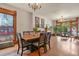 Spacious dining room with hardwood floors, chandelier lighting, and large windows for ample natural light at 1160 York St, Denver, CO 80206