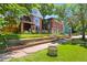Landscaped front yard with brick accents and a sidewalk, showcasing the curb appeal of the classic home at 1160 York St, Denver, CO 80206