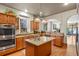 Well-lit kitchen boasting stainless steel appliances, wood cabinets, granite countertops and hardwood floors at 1160 York St, Denver, CO 80206