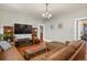 Comfortable living room featuring hardwood floors, a flat-screen TV, and a leather sofa at 1160 York St, Denver, CO 80206