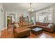 Bright living room featuring a leather sofa, hardwood floors, and a decorative window at 1160 York St, Denver, CO 80206