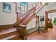 Beautiful staircase featuring hardwood floors, stained glass windows, and wooden banisters at 1160 York St, Denver, CO 80206