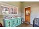 Sunroom with lots of natural light and a bright painted vintage cabinet at 1160 York St, Denver, CO 80206