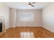 Bright living room boasts a fireplace, hardwood floors, ceiling fan, large window and neutral color palette at 15625 Carob Cir, Parker, CO 80134