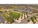 Aerial view showcasing a vibrant neighborhood with modern homes surrounding a well-manicured green space at 4958 Valentia Ct, Denver, CO 80238