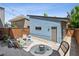 Charming backyard with patio seating, a gravel area, and a detached garage, perfect for outdoor enjoyment at 4958 Valentia Ct, Denver, CO 80238