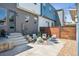 Inviting backyard with a concrete patio, string lights, comfortable seating, and a well-manicured gravel area at 4958 Valentia Ct, Denver, CO 80238