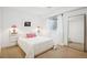 Serene bedroom features clean white walls, a plush bed, and minimalist decor with modern lighting at 4958 Valentia Ct, Denver, CO 80238