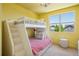 Cozy bedroom with bunk beds, natural light, and colorful decor for a fun and inviting space at 4958 Valentia Ct, Denver, CO 80238