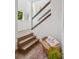 Bright foyer with hardwood floors and staircase and a decorative accent bench at 4958 Valentia Ct, Denver, CO 80238