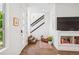 Bright foyer with hardwood floors, modern staircase, and stylish decor at 4958 Valentia Ct, Denver, CO 80238