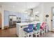 Modern kitchen featuring a breakfast bar with seating, stainless steel appliances, and blue cabinetry at 4958 Valentia Ct, Denver, CO 80238