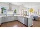 Modern kitchen featuring stainless steel appliances, white quartz countertops, and hardwood flooring at 4958 Valentia Ct, Denver, CO 80238