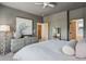 Serene bedroom with a neutral color palette, plush bedding, and an ensuite bathroom at 4958 Valentia Ct, Denver, CO 80238