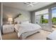 Bright bedroom with a stylish headboard, large window, and access to a private balcony at 4958 Valentia Ct, Denver, CO 80238