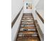 Unique staircase with hardwood treads and glass railings leading to upper levels at 4958 Valentia Ct, Denver, CO 80238