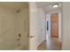 Bathroom with tub, shower, grab bar, and wood floor at 10588 Parkington Ln # 39A, Highlands Ranch, CO 80126