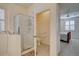 Bathroom with walk-in tub, walk-in shower, toilet, and view into a bedroom with a ceiling fan at 10588 Parkington Ln # 39A, Highlands Ranch, CO 80126
