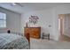 A comfortable bedroom featuring wooden furniture, carpeted floors, an artful wall decoration, and soft, natural light at 10588 Parkington Ln # 39A, Highlands Ranch, CO 80126